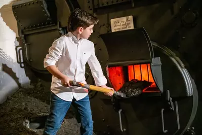 kid shoveling coal in the Titanic Boiler Room